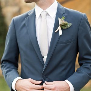 groom in a suit outdoors