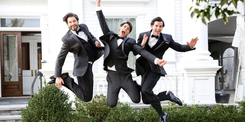 Men wearing formalwear jumping