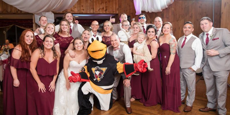 A wedding party posing with the Pittsburg stealers mascot