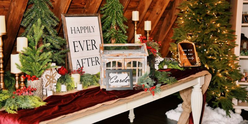 A detail shot of a table decorated with Christmas frills with a sign that says happily ever after