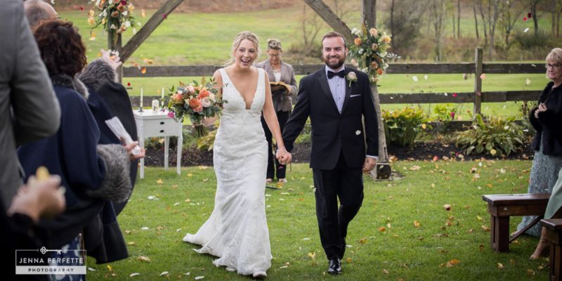 A newlywed couple walking down the aisle after getting married