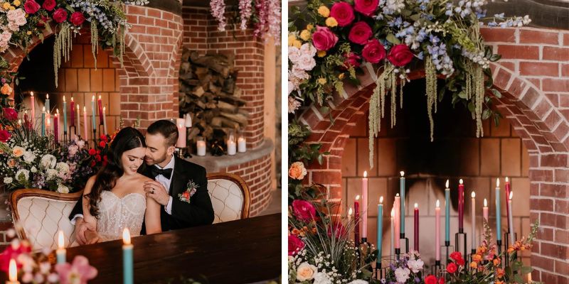 A couple wearing formalwear sitting at a well decorated table full of florals and candles
