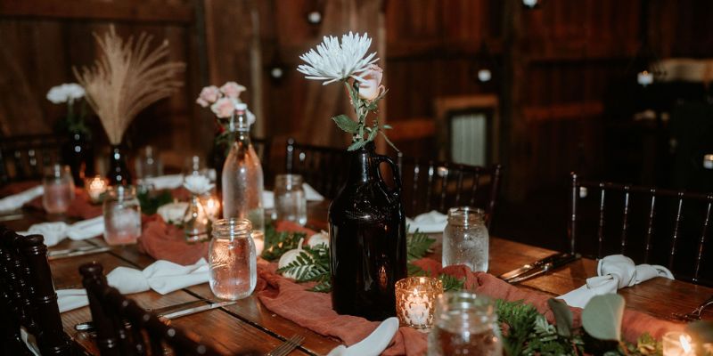 A detail shot of florals and jars on a wedding table
