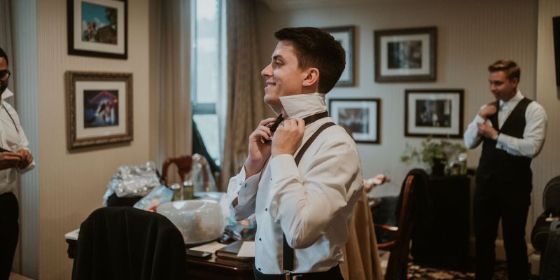 A groom getting dressed