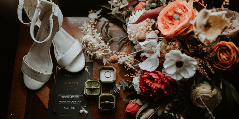 A detail shot of shoes, rings, and florals