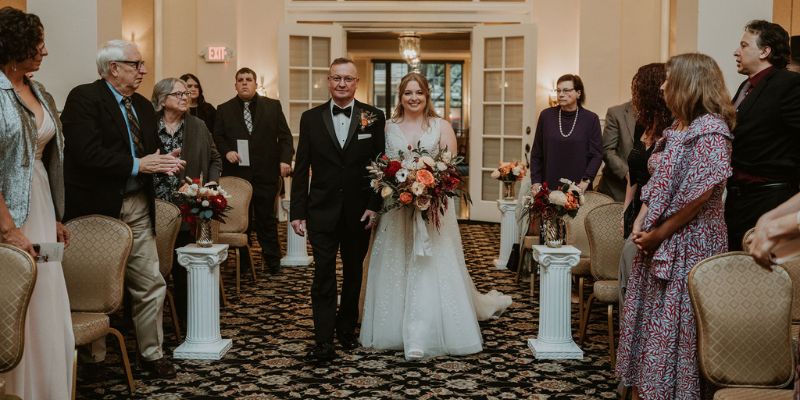 A bride getting walked down the aisle by her father