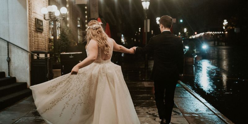 A newlywed couple walking holding hands