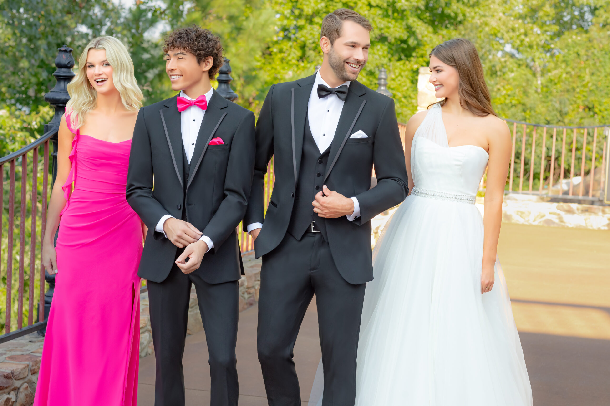 a group of people in formal attire bride and groom with groomsman and bridesmaid rental tuxedos