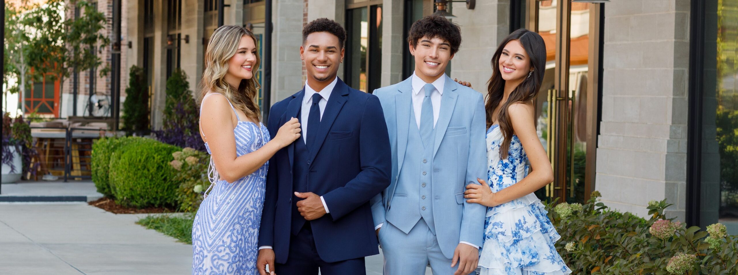 four students dressed for prom in their tuxedo by sarno suit rentals