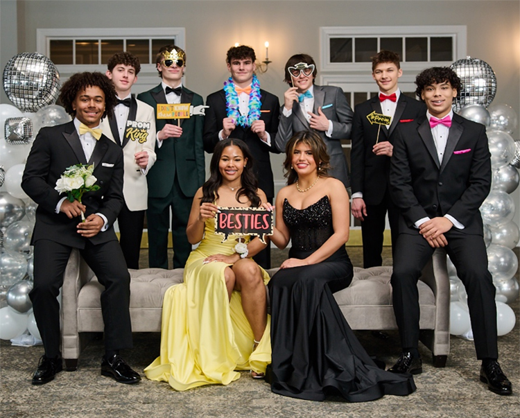 Nine teenagers dressed in formal prom attire